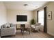 Comfortable living room featuring a cozy couch, modern furniture, and entertainment center at 1143 Park Hollow Ne Ln, Lawrenceville, GA 30043