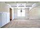 Bright living room with coffered ceiling, large windows, and wainscoting at 1143 Park Hollow Ne Ln, Lawrenceville, GA 30043