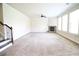 Large living room featuring a stone fireplace and ample natural light at 1143 Park Hollow Ne Ln, Lawrenceville, GA 30043