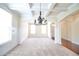 Elegant living room featuring coffered ceiling, chandelier, and hardwood floors at 1143 Park Hollow Ne Ln, Lawrenceville, GA 30043
