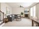 Cozy living room featuring a fireplace, plush gray sectional, modern decor, and a ceiling fan at 1143 Park Hollow Ne Ln, Lawrenceville, GA 30043