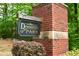 Elegant Devonshire Park sign set against a brick pillar and greenery, showcasing community charm at 1143 Park Hollow Ne Ln, Lawrenceville, GA 30043