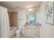 Bright bathroom featuring a shower-tub combo, granite vanity, and modern fixtures at 3324 Peachtree Ne Rd # 1104, Atlanta, GA 30326