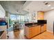 Open-concept kitchen with modern cabinets, black backsplash, and view of the living room at 3324 Peachtree Ne Rd # 1104, Atlanta, GA 30326