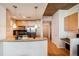 Modern kitchen with stainless steel appliances, light wood cabinets, and a granite breakfast bar at 3324 Peachtree Ne Rd # 1104, Atlanta, GA 30326