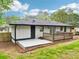 Outdoor patio area featuring a wooden deck, sliding glass doors, and fenced yard at 117 Hillsdale Dr, Atlanta, GA 30315