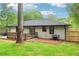 View of the home's backyard featuring a patio and wooden deck surrounded by green grass at 117 Hillsdale Dr, Atlanta, GA 30315