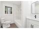 Modern bathroom featuring a toilet, shower/tub, and vanity with a vessel sink and marble accent tiles at 117 Hillsdale Dr, Atlanta, GA 30315
