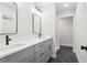 Bathroom with double sink vanity, black hardware, and walk-in shower with marble tile at 117 Hillsdale Dr, Atlanta, GA 30315