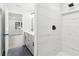 Bathroom with marble tiled shower, sink, and view into the bright bedroom with wood floors at 117 Hillsdale Dr, Atlanta, GA 30315