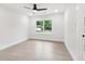 Bright bedroom featuring wood floors, a ceiling fan, and a window with neighborhood views at 117 Hillsdale Dr, Atlanta, GA 30315
