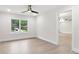 Bright bedroom with wood floors, a modern ceiling fan, and an open doorway to another room at 117 Hillsdale Dr, Atlanta, GA 30315