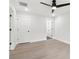 Bedroom with wood floors featuring ceiling fan and multiple interior door and closet access at 117 Hillsdale Dr, Atlanta, GA 30315