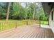 Large wood deck overlooking a grassy, tree-lined yard, enhancing outdoor enjoyment and relaxation at 117 Hillsdale Dr, Atlanta, GA 30315
