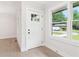 Bright foyer featuring a glass-paneled front door, fresh white paint, and modern flooring at 117 Hillsdale Dr, Atlanta, GA 30315