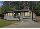 Charming home showcasing a manicured lawn and shuttered windows, complete with a concrete driveway at 117 Hillsdale Dr, Atlanta, GA 30315