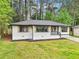 Inviting single-story home with fresh white brick, dark trim, and a newly landscaped front yard at 117 Hillsdale Dr, Atlanta, GA 30315