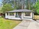 Charming single-story home with freshly painted white brick, dark trim, and well-manicured front lawn at 117 Hillsdale Dr, Atlanta, GA 30315
