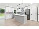 Modern kitchen with white cabinets, stainless steel appliances, and a gray kitchen island at 117 Hillsdale Dr, Atlanta, GA 30315