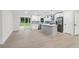 Open kitchen with stainless appliances, gray kitchen island, and adjacent living room for easy entertaining at 117 Hillsdale Dr, Atlanta, GA 30315