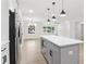 Stylish kitchen boasts white countertops, stainless steel appliances, gray island and seamless access to living room at 117 Hillsdale Dr, Atlanta, GA 30315