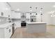 Well-lit kitchen featuring white cabinets, stainless steel appliances, and a center island at 117 Hillsdale Dr, Atlanta, GA 30315