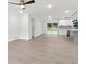 Open-concept living room with sleek flooring flows into a modern kitchen with stainless steel appliances at 117 Hillsdale Dr, Atlanta, GA 30315