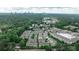 An aerial view shows rooftops of townhomes surrounded by lush green trees with a city skyline in the distance at 247 Franklin Rd, Atlanta, GA 30342