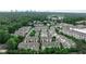An aerial view shows rooftops of townhomes surrounded by lush green trees with a city skyline in the distance at 247 Franklin Rd, Atlanta, GA 30342