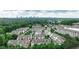 An aerial view showing rooftops of townhomes surrounded by lush green trees with a city skyline in the distance at 247 Franklin Rd, Atlanta, GA 30342