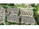 An aerial view shows townhome rooftops with a manicured landscape, driveways, and green space nestled in a sought-after location at 247 Franklin Rd, Atlanta, GA 30342