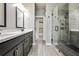 Bathroom featuring a double vanity, walk-in shower, and tile floors at 247 Franklin Rd, Atlanta, GA 30342