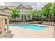 Community pool surrounded by lounge chairs, lush landscaping, and well-maintained brick townhomes in a desirable location at 247 Franklin Rd, Atlanta, GA 30342