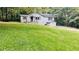 Single story home with a well-manicured lawn and mature trees at 33 Stratford Nw Dr, Atlanta, GA 30311