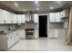 Modern kitchen features stainless steel appliances, white cabinets, and recessed lighting at 33 Stratford Nw Dr, Atlanta, GA 30311