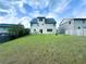 Spacious backyard featuring a well-maintained lawn, perfect for outdoor activities, along with a patio seating area at 545 Eldridge Dr, Suwanee, GA 30024