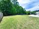 Picturesque backyard with lush greenery and ample space, featuring a patio for outdoor enjoyment and privacy fencing at 545 Eldridge Dr, Suwanee, GA 30024