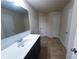 Bathroom featuring a large mirror, modern vanity, neutral walls, and tiled flooring for a clean design at 545 Eldridge Dr, Suwanee, GA 30024