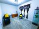 A bedroom that has been converted to a salon, with dark seating and a yellow accent pillow at 545 Eldridge Dr, Suwanee, GA 30024