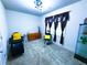 A bedroom that has been converted to a salon, with dark seating and a yellow accent pillow at 545 Eldridge Dr, Suwanee, GA 30024