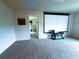 Large carpeted bonus room with projector screen and adjacent room view at 545 Eldridge Dr, Suwanee, GA 30024