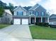 Lovely two-story brick home with a well-maintained lawn, inviting porch, and a convenient two-car garage at 545 Eldridge Dr, Suwanee, GA 30024