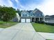 Attractive two-story brick home featuring a well-kept lawn, covered porch, and spacious driveway at 545 Eldridge Dr, Suwanee, GA 30024