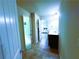 Hallway with neutral tile floors connecting to a bedroom, and bathroom, providing easy access to essential areas at 545 Eldridge Dr, Suwanee, GA 30024