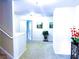 Bright hallway with neutral carpeting, white trim, decorative plants and artwork creates a warm, inviting atmosphere at 545 Eldridge Dr, Suwanee, GA 30024
