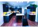Well-equipped kitchen featuring dark cabinets, stainless steel appliances, granite countertops, and a central island at 545 Eldridge Dr, Suwanee, GA 30024