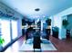 Open floor plan showcasing a modern kitchen with island and dining space with glass table set at 545 Eldridge Dr, Suwanee, GA 30024