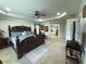 Large main bedroom with tray ceilings, a ceiling fan, and ensuite bathroom at 545 Eldridge Dr, Suwanee, GA 30024