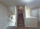 Carpeted staircase with white railing and neutral walls leads to the upper level at 545 Eldridge Dr, Suwanee, GA 30024