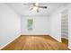 Bedroom with wood-look flooring, ceiling fan, window, and a walk-in closet with shelving at 901 Gettysburg Pl, Atlanta, GA 30350
